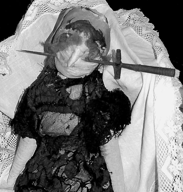 Photograph of a doll used in a curse
